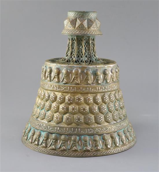 A 13th century Khorassan silver and copper inlaid bronze candlestick, H.10.5in.